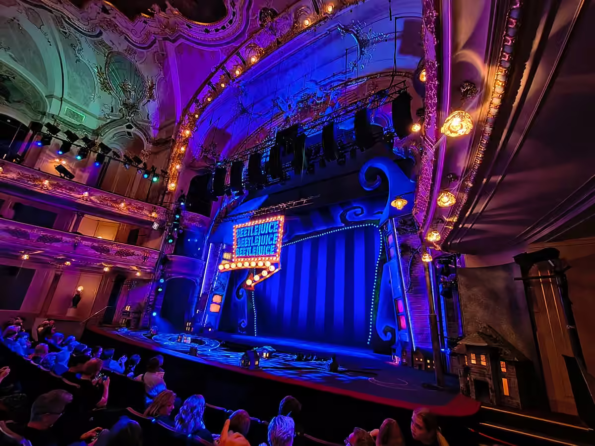 A wide view of the Beetlejuice stage and historic auditorium at Hudební divadlo Karlín.