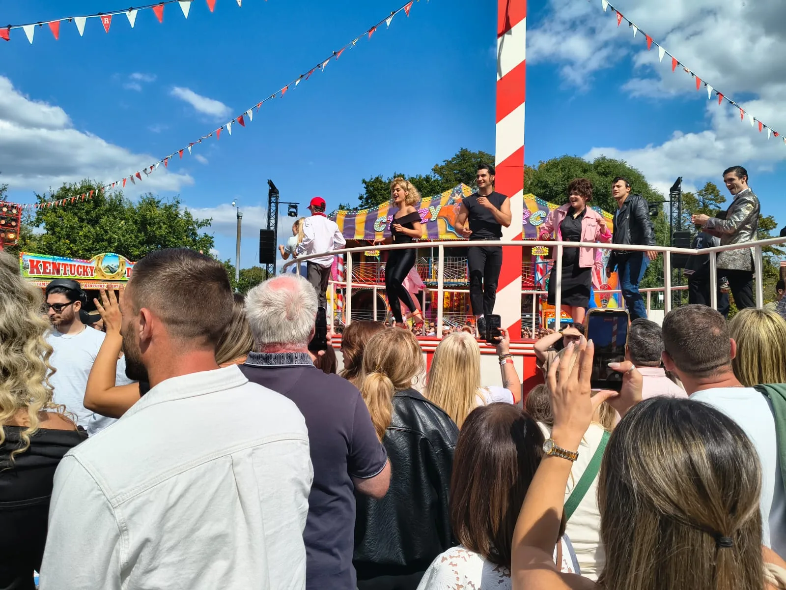 Audience members gathered around a live performance during Grease: The Immersive Movie Musical.