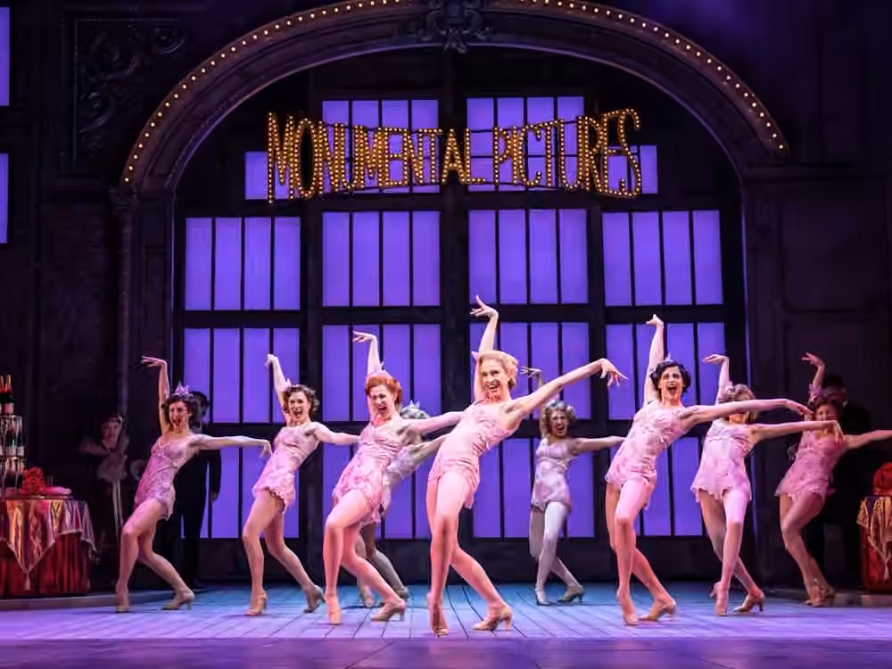 The company performs in front of the Monumental Pictures set in Singin’ in the Rain.