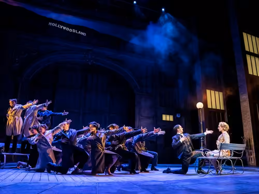 The company performs a scene on a Hollywood-inspired set in Singin’ in the Rain.